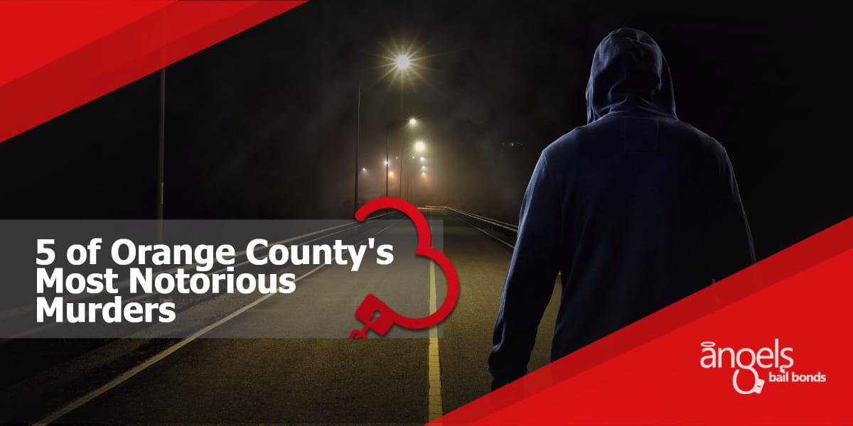 a hooded man standing on the road at night